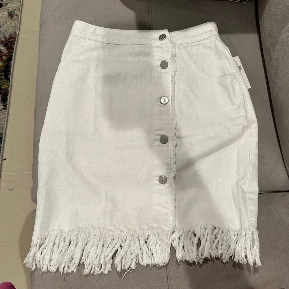 White anthropology skirt, with fringe detail at bottom.